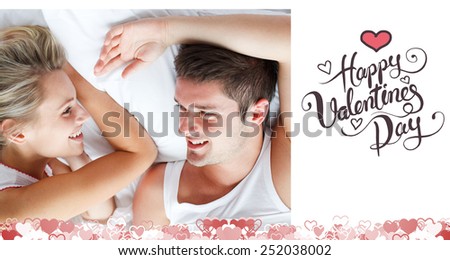 Couple relaxing in bed against happy valentines day
