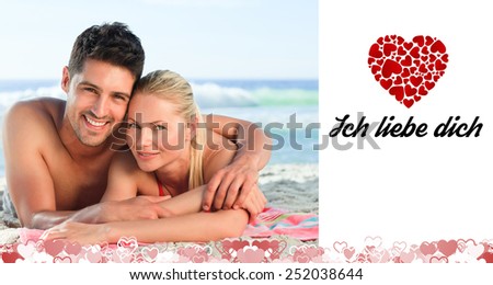 Lovers lying down on the beach against ich liebe dich
