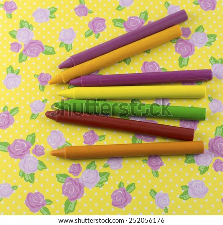 Crayons on the flower background paper