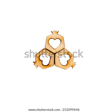 Three hearts arranged in the shape of a flower isolated on white. Three pomegranate carved of wood.