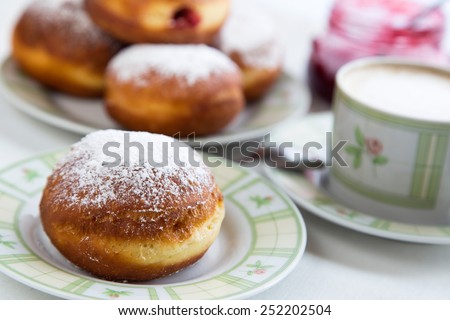 Donuts with jam and icing sugar