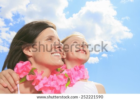 family, childhood, happiness and people - smiling mother and little girl over blue sky