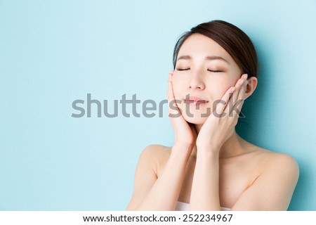 attractive asian woman skin care image on blue background Royalty-Free Stock Photo #252234967