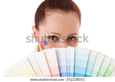 The beautiful young woman with a color guide on a white background. Designer of interior.