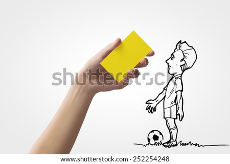 Caricature of football player and human hand showing yellow card