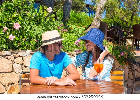 Young couple relaxing in outdoor cafe