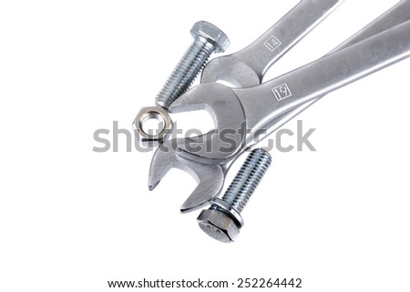 Several combination wrenches and a couple of bolts on a white background