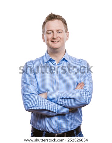 Happy young man in blue shirt posing. Studio shot on white background.