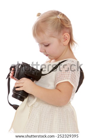 Very serious blond girl looks at the screen of the camera.Isolated on white background, Lotus Children's Center.