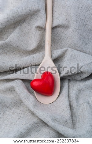red heart in a wooden spoon