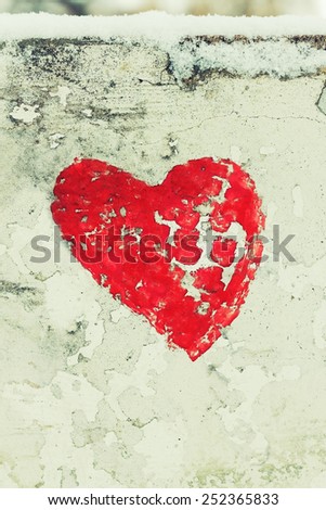 Red Love Heart hand drawn on concrete wall grunge textured background. Winter season, closeup, vertical shot