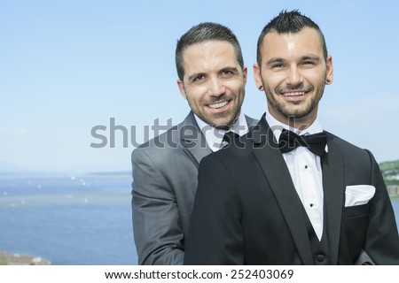 Portrait of a loving gay male couple on their wedding day. Royalty-Free Stock Photo #252403069
