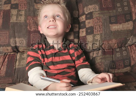 A children with a book on the sofa