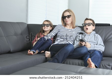 family sitting on a sofa in her living room
