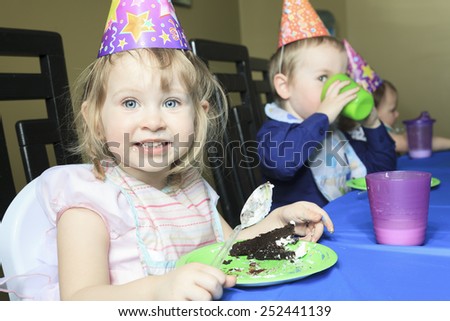 A children birthday with the kid eat cake.