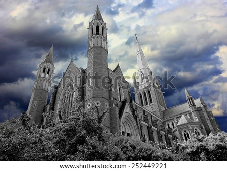 Dark haunted church converted to black and white with dark moody coloured storm clouds