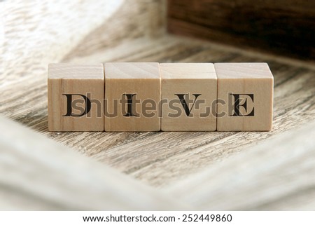 the word of DIVE on wooden cubes