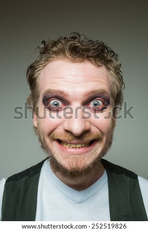 prortret smiling bearded man with makeup.