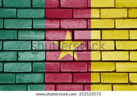 Cameroon flag painted on old brick wall texture background