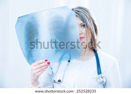 Doctor examining an X-ray light