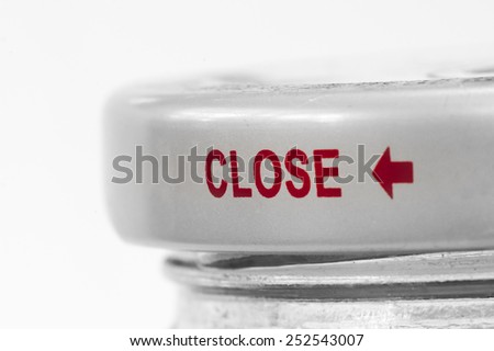 Text "CLOSE" on a cap pf glass bottle (concept)