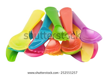 Plastic spoons, knives, forks violet, orange, yellow, blue, red isolated on the white