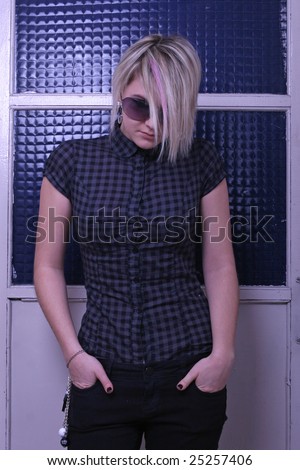 depressed emo girl standing near door and looking down