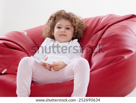 the child sitting on the furniture frame less isolated on the white background