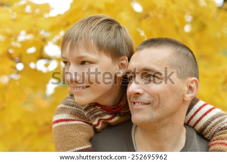 Portrait of father and son in autumn park