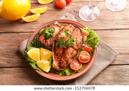 Tasty baked fish on plate on table close-up Royalty-Free Stock Photo #252706078
