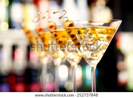Several glasses of famous cocktail Martini, shot at a bar with shallow depth of field
