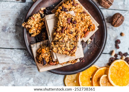 granola bars citrus, peanut butter and dried fruit, Healthy eating concept with cereal bar Royalty-Free Stock Photo #252738361