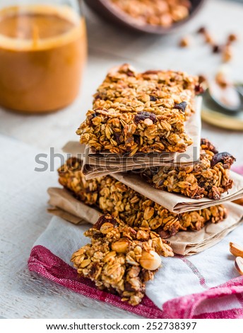 protein bars granola with seeds, peanut butter and dried fruit, healthy snack on wooden background Royalty-Free Stock Photo #252738397