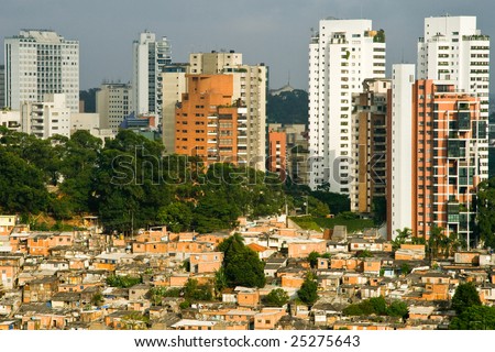 Picture of a favela in the Morumbi neighborhood in the city of Sao Paulo, contrasting against the expensive buildings in the background.