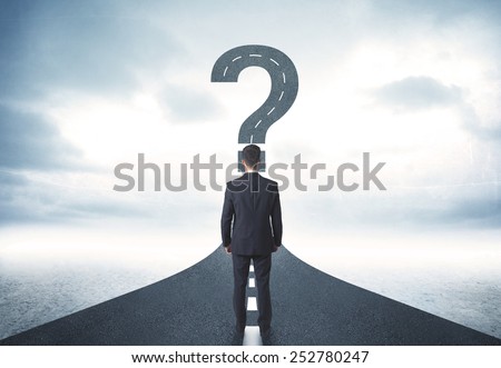 Business person lokking at road with question mark sign concept