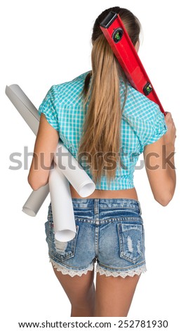 Pretty woman in shorts and shirt smiling and holding paper scrolls and red building level. Rear view. Isolated over white background