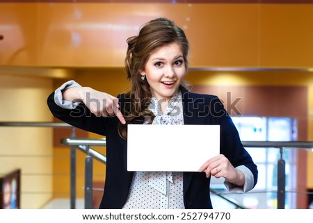 Smiling young beautiful women shows on blank white card