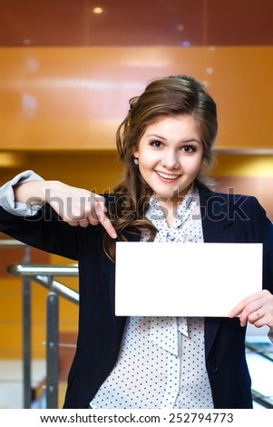 Smiling young beautiful women shows on blank white card