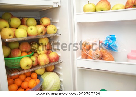 fridge with apples, healthy food concept, fresh fruits storage, vegetarian diet for slim and health, raw fruit eating for healthy life and feeling good, vegetarian food in fridge