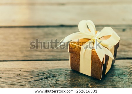Gift box on wooden table - Vintage effect style pictures