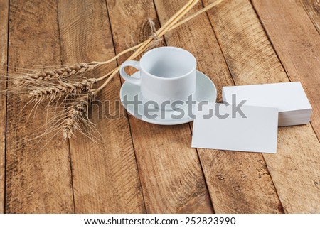 Photo of business cards. Template for branding identity. For graphic designers presentations and portfolios. With wheat spikelets on wooden background.