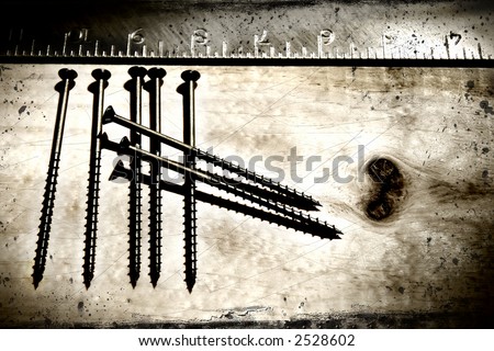 Screws and ruler on a grunge wood background/ Ideal for construction concepts, business card, etc...