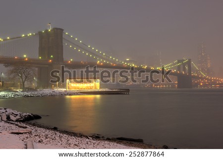Manhattan Skyline and the Brooklyn Bridge from Brooklyn during a winter snowstorm.