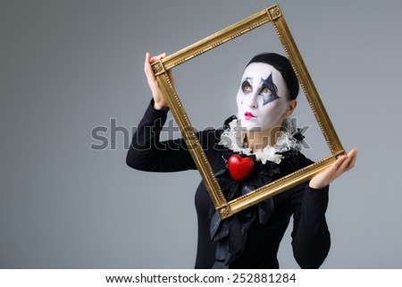 Woman in disguise harlequin in the picture frame