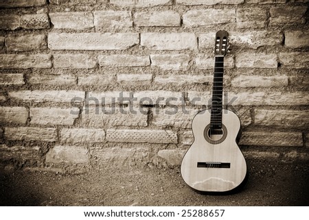 Classic guitar over old brickwall