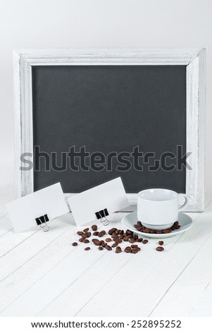 Photo of business cards. Template for branding identity. For graphic designers presentations and portfolios. Coffee cup and grain on white wooden background. Writing board.
