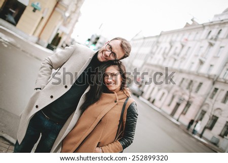 Young couple hugging on the date in the city street in winter