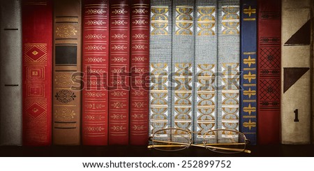 glasses on the background of books
