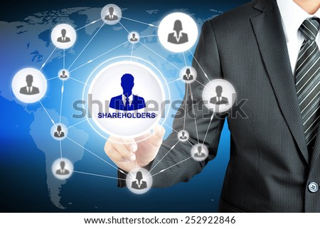 Businessman pointing on SHAREHOLDERS sign on virtual screen with people icons linked as network
