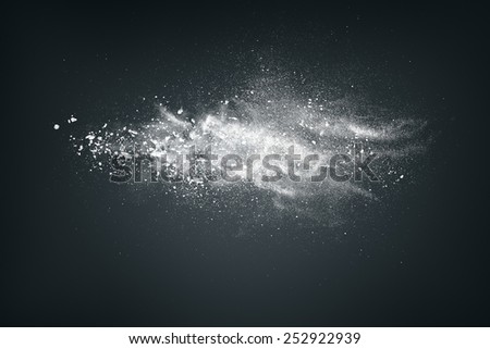 Abstract design of white powder cloud against dark background Royalty-Free Stock Photo #252922939